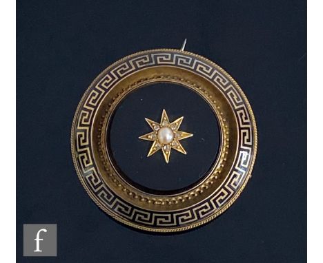 A 19th Century 9ct circular memorial brooch with central split pearl and diamond set star to a black onyx base, all within bl