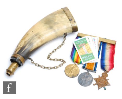 A trio of three World War One medals awarded to Pte.F. Rook North. N.R., a brass capped horn powder flask and a replica set o