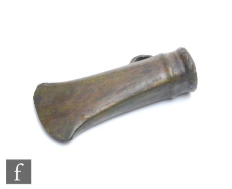 A small looped and socketed bronze age axe head, length 10cm. 