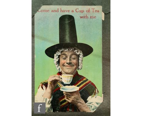 An Edwardian album of postcards to include real photographic cards of buildings and hotels, two albums of greetings and birth
