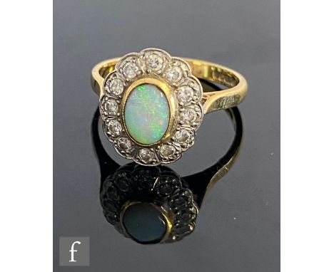 An 18ct hallmarked opal and diamond cluster ring, central collar set oval opal, length 7.5mm, within a border of twelve brill