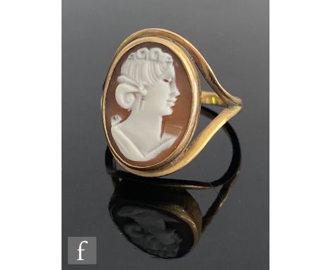 A 9ct hallmarked oval cameo ring profile of a classical women, collar set to split shoulders, weight 4.1g, ring size R. 