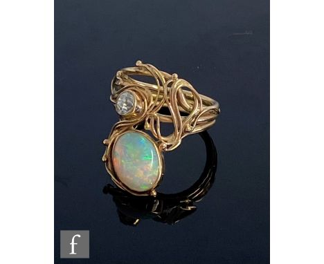 A 9ct hallmarked Art Nouveau style opal and diamond two stone ring, oval collar set opal, length 11mm, below a old cut diamon