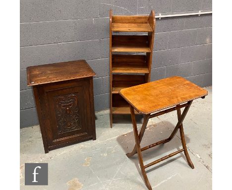 A Victorian oak cupboard enclosed by a carved scroll and boss panel door, height 74cm x depth 43cm x width 56cm, a small stri