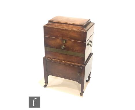 A George III small cellarette, the caddy shaped top opening to reveal six divisions, twin carrying handles and brass banded, 