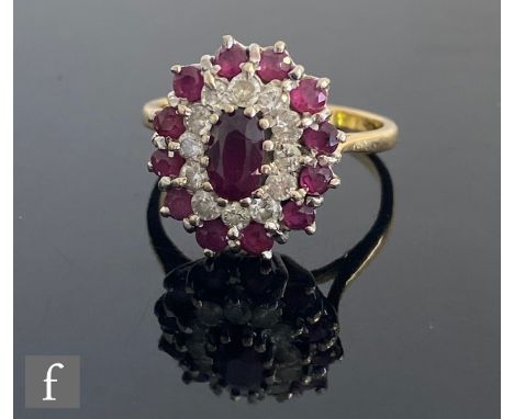 An 18ct ruby and diamond oval target cluster ring, central ruby within diamond surround all within a ruby set border, weight 