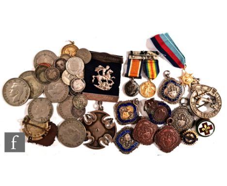 A small collection of commemorative silver and enamel badges including a pair of First World War One miniatures, a gilt minia