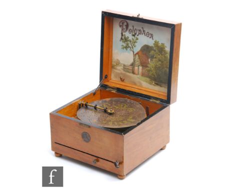 A Polyphon playing 20.5cm discs, single comb, lever wind operation, in walnut case, the underside of the lid labelled with a 
