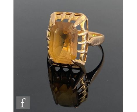 An 18ct single stone citrine ring, claw set emerald cut stone to plain shoulders, weight 4.4g, ring size P. 