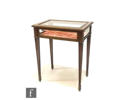 A late 19th Century French mahogany and gilt metal mounted bijouterie cabinet, bevelled glass sides and top, on reverse panel