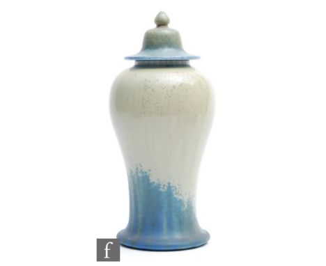 A Ruskin Pottery Mei Ping shaped vase and cover decorated in a glossy light green to matt dark blue with speckled crystalline