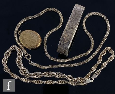 Four items of hallmarked silver jewellery, two chains, a hinged bangle and a gilt oval locket, total weight 116.5g. (4) 