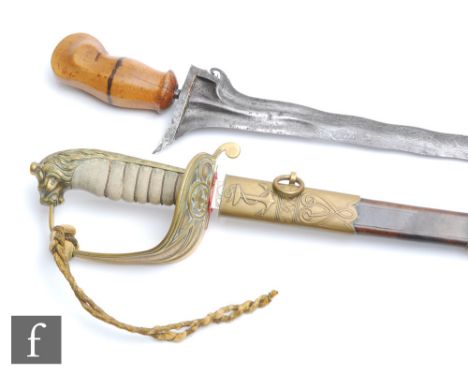 A 20th Century officer's dress sword and scabbard with ray skin handle and lion pommel and a Kris dagger with carved handle, 