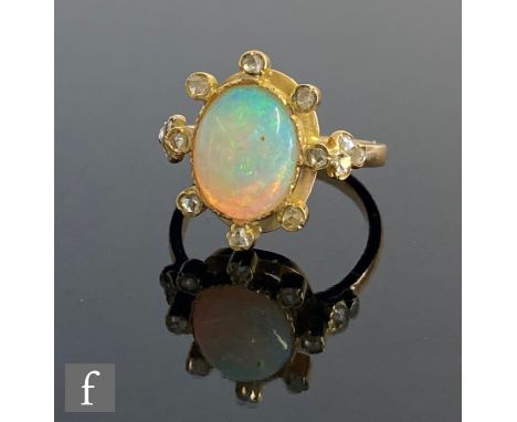 A 18ct opal and diamond cluster ring, central collar set oval opal, length 10mm, within a border of eight individually set di