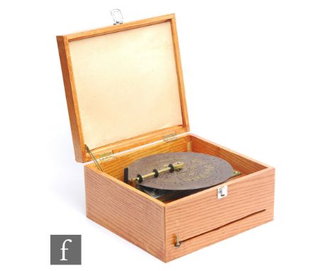 A 19th Century Polyphon playing 9 1/2 inch discs, single comb, in later case with one original and three replica discs. 