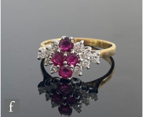An 18ct hallmarked ruby and diamond horizontal marquise shaped cluster ring comprising four central rubies flanked by five di