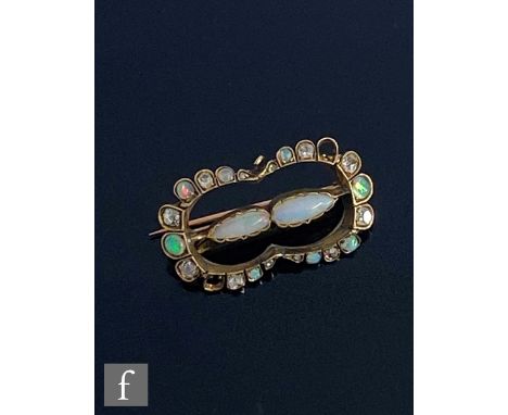 A late 19th Century gold diamond and opal set brooch with two central pear shaped opals within an alternating diamond and opa