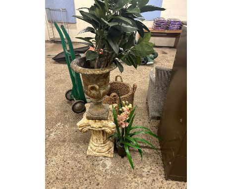 A resin garden planter modelled as an urn on plinth