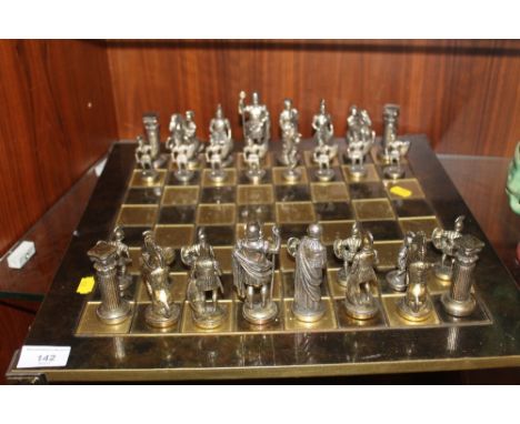 A BRASS EFFECT CHESS SET AND BOARD