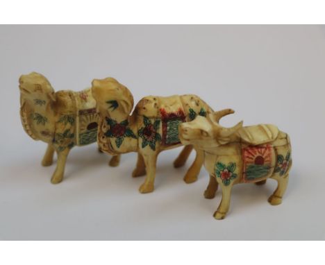 Three bone netsuke type figures of a money cow and 2 x camels/lamas