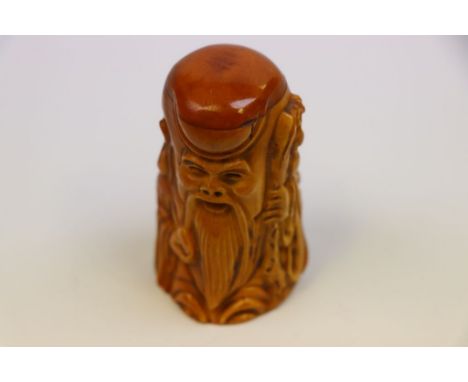 Bone netsuke of an old man with stake and gold 