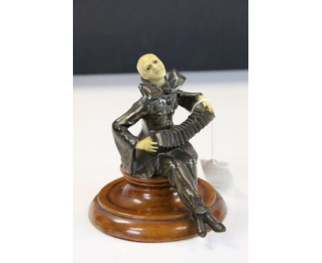 Bronze effect Pierrot type figure playing the Accordion with Celluloid Head &amp; hands and on a turned Wooden base, stands a