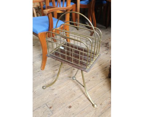 An Edwardian brass and mahogany magazine/music rack on shaped tripod base 