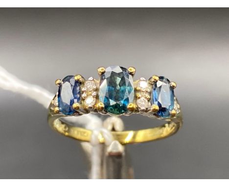 A sapphire and diamond ring the oval sapphires interspersed with diamonds 9ct