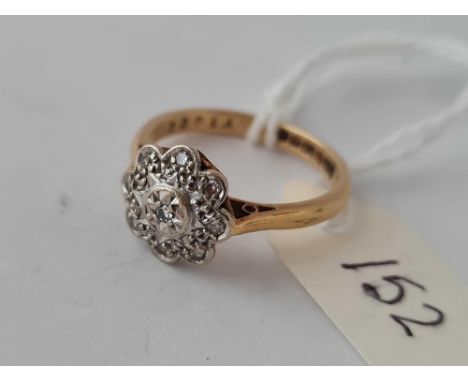 A diamond flower head ring 18ct gold size L   3.4 gms