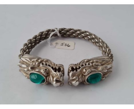 A impressive silver rope twist bangle with two stone set dragons head
