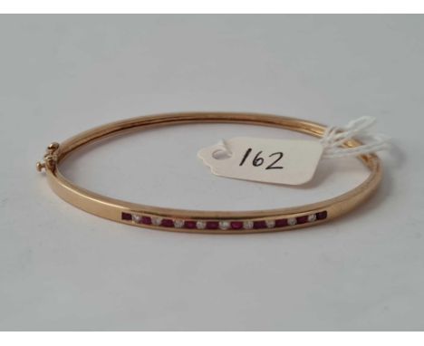 A RUBY AND DIAMOND BANGLE 9CT GOLD      8 GMS