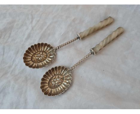 Pair of preserve spoons with embossed bowls and M O P handles. Sheffield 1884 By R E H