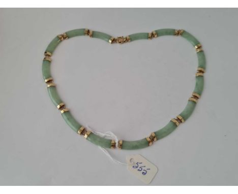 A nice gold and green jade necklace 9ct   24.5 gms boxed