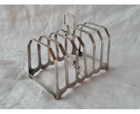 A seven bar toast rack with ring handle, 4.5" wide, Birmingham 1938 by SB &amp; S, 112g