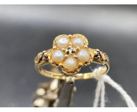 A pretty Georgian style pearl and emerald cluster ring with emerald shoulders