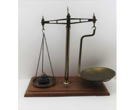 A SET OF 'VANDOME, TITFORD &amp; CO. LTD' LONDON BRASS BALANCE SCALES, on mahogany base board, with graduated sets of weights