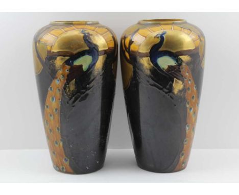 THOMAS FORRESTER &amp; SONS A PAIR OF PHOENIX WARE CERAMIC VASES, glazed and gilded with peacock decoration, 31cm high 