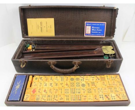 A MID 20TH CENTURY MAH-JONG GAME, with tiles, and rule / guide book, possibly American, the case 50cm wide 