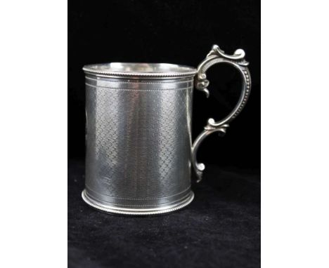 MARTIN HALL & CO. A VICTORIAN SILVER CHRISTENING TANKARD of cylinder form with applied cast scroll handle, the body engine tu