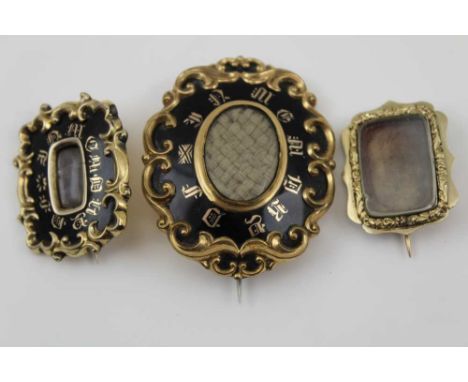 THREE VICTORIAN GOLD &amp; SILVER MOUNTED MOURNING BROOCHES, one oval hair inset with tooled scrolls &amp; enamel surround 5c