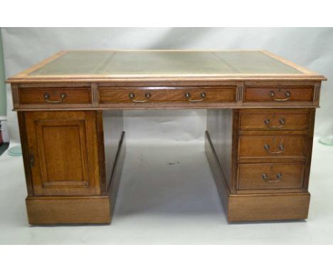 A LATE 19TH CENTURY OAK TWIN PEDESTAL PARTNERS DESK, having skiver insert top over three inline drawers, supported on two col