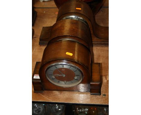 A 1950s oak cased mantel clock, having a silvered chapter ring with Arabic numerals, chiming movement, w.42cm; together with 