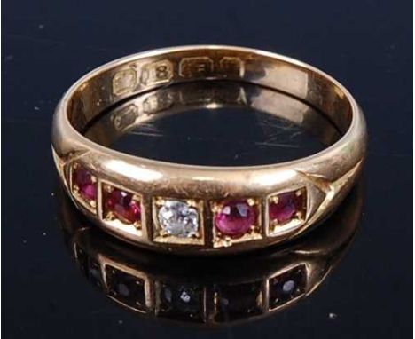 An 18ct gold, ruby and diamond set half hoop ring, the centre round cut diamond weighing approx 0.07 carats, 3.8g, size P