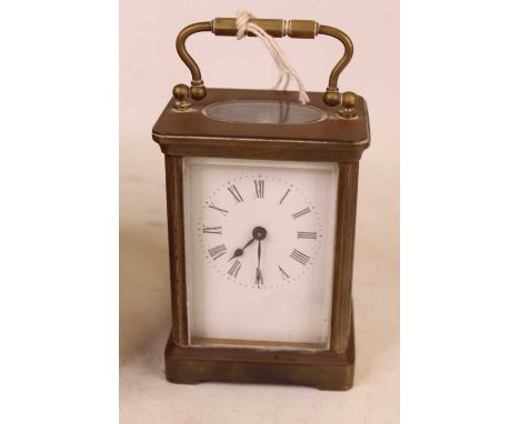 An early 20th century brass cased carriage clock, having an enamelled dial with Roman numerals and platform lever escapement,