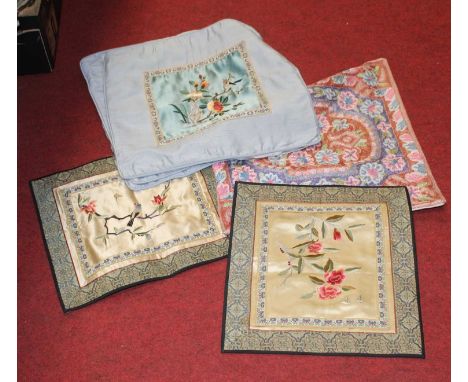 A pair of silk panels each embroidered with birds and flowers, together with three embroidered cushion covers, one other crew