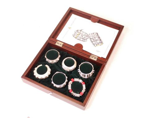 A boxed set of six white metal Omani napkin rings, each a miniature replica of an anklet or bangle of the Dhofar region of So