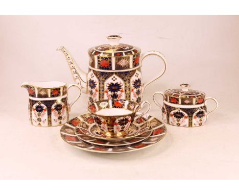 A Royal Crown Derby three-piece tea service, decorated in the imari palette, numbered 1128, to include teapot, sucrere and mi