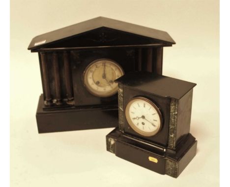 A late Victorian black slate mantel clock, of architectural form, having an enamelled dial with Arabic numerals and eight day