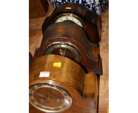 A 1930s walnut cased mantel clock, having raised Arabic numerals and eight day movement, w.31cm; together with two oak cased 