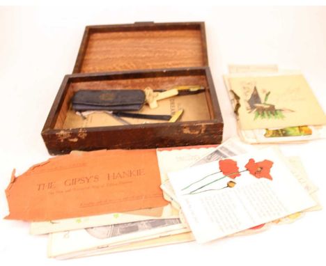 A leather clad box to include Duke of York's Theatre programme, greetings cards, pocket knives etc 